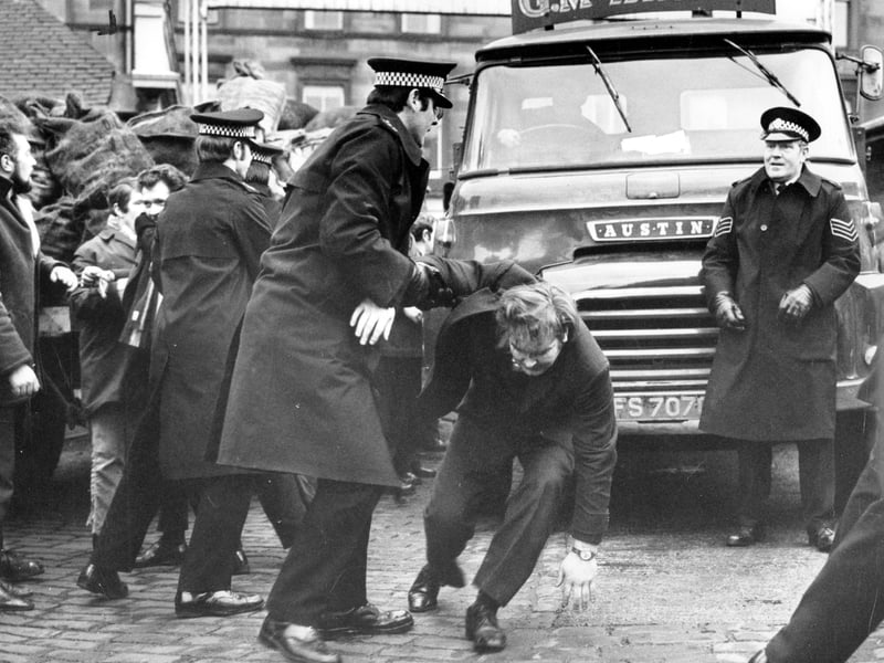 Police move in when pickets mob the driver of a lorry collecting coal from the Haymarket coal depot in Edinburgh during the miners' strike of 1972.
