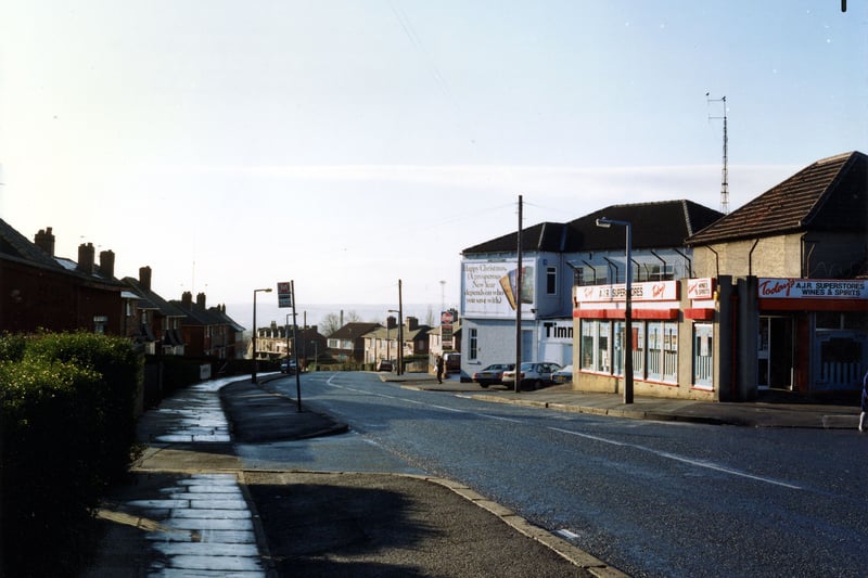 looking south along Osmondthorpe Lane, showing A.J.R. Superstores, general grocer and off licence, at no. 84 on the right. Beyond this is Timmerdales ice cream factory with an advertising hoarding on the wall. The junction with Ings Road follows this, and semi-detached housing can be seen further down and on the left of the photo from January 1991.