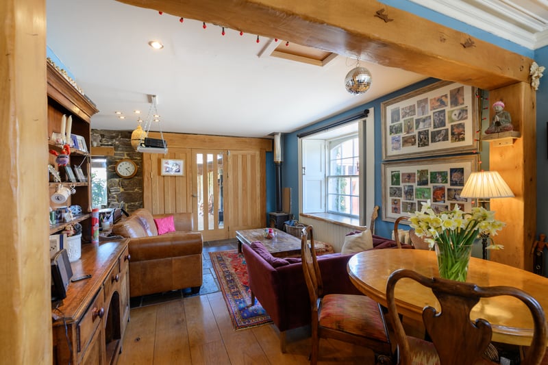 The open-plan kitchen, dining and sitting area is kept cosy by a wood-burner in the corner.