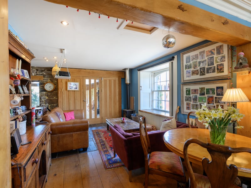 The open-plan kitchen, dining and sitting area is kept cosy by a wood-burner in the corner.