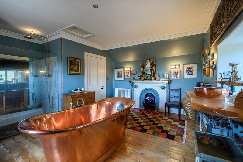 On the first floor of the original house are two double bedrooms and two bathrooms, one of which boasts a free-standing copper bath, a large shower, and original fireplace.