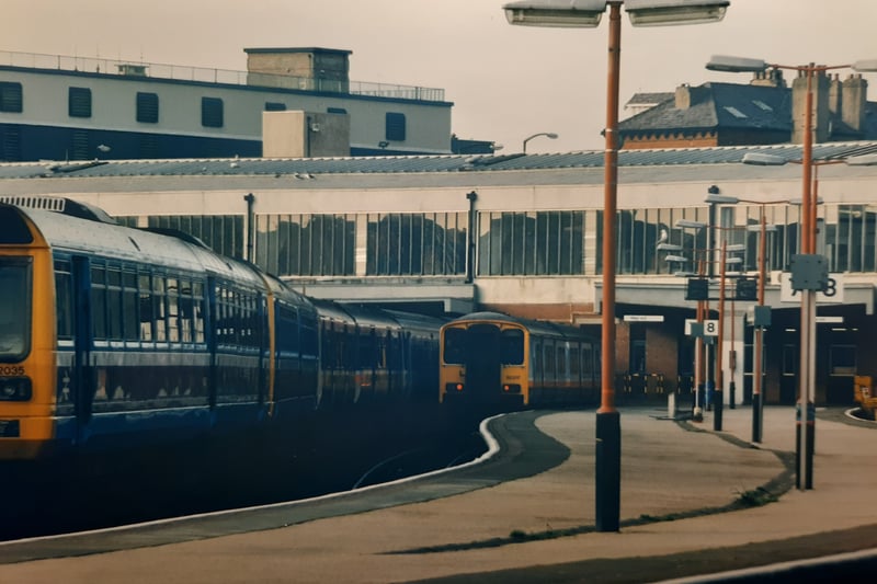 The old diesel trains pulling out of the station in April 1993