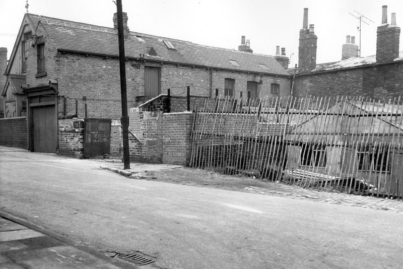 Folly Lane on the far left with the Good Physician Church of England Mission Room behind. On the right is the entrance to a yard with warehouses and sheds shown on the far right behind the fence. Pictured in October 1963.