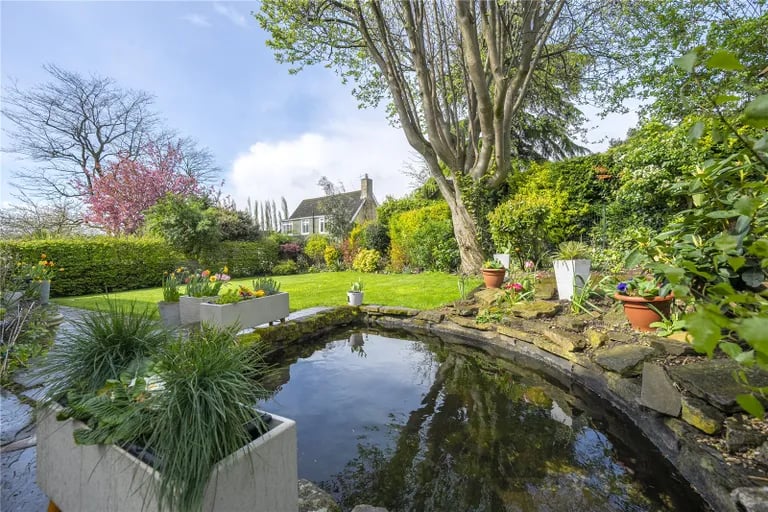 A pond adds extra charm to the tranquil garden.