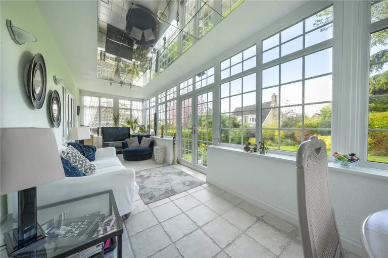 The gorgeous conservatory is a real showstopper. From here, French doors leads onto the rear garden.