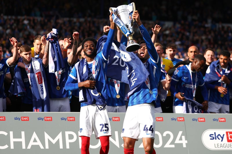 Delighted loan duo Abu Kamara and Myles Peart-Harris hold aloft the league winner's trophy
