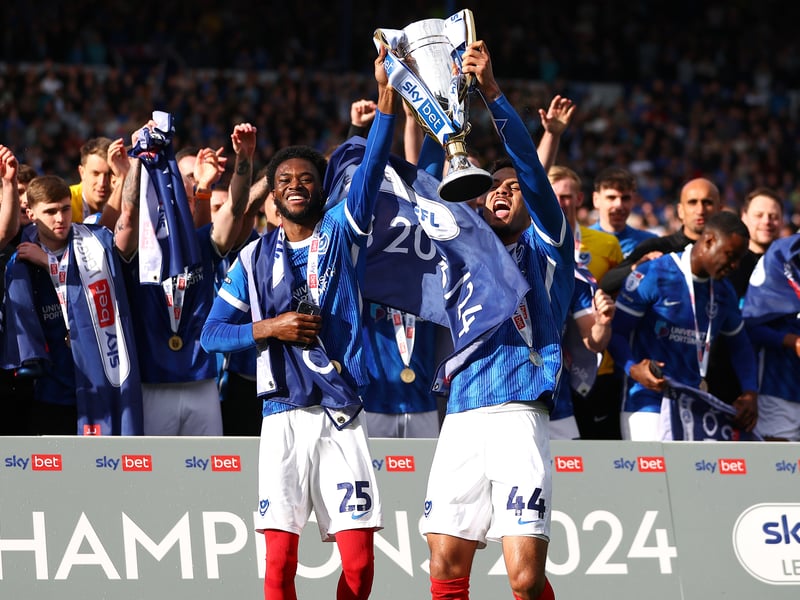 Delighted loan duo Abu Kamara and Myles Peart-Harris hold aloft the league winner's trophy