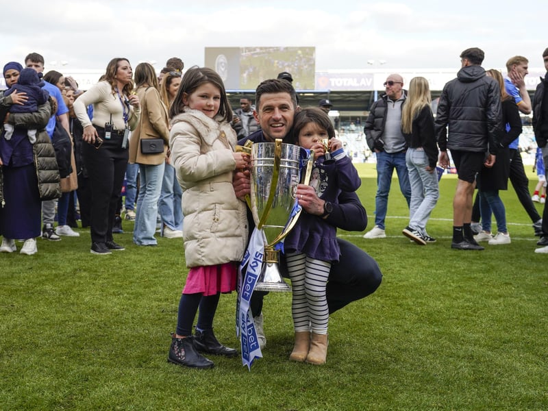 A lovely family moment as John Mousinho celebrates with his two daughters on the pitch at Fratton Park