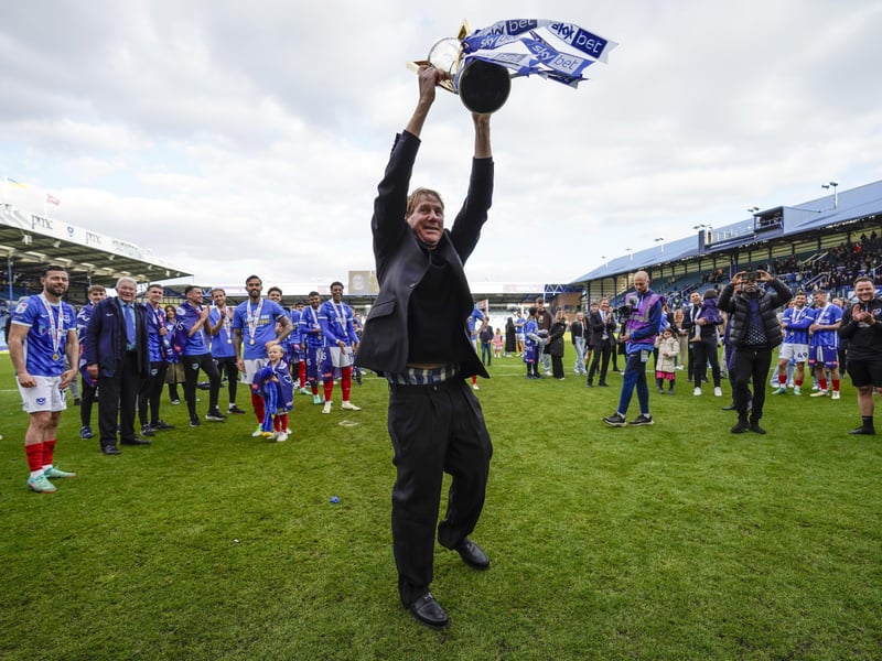 Pompey director Eric Eisner with the League One champions trophy in front of the Fratton End