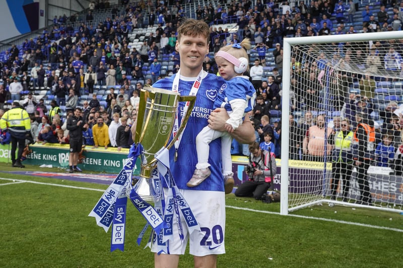 Sean Raggett with his daughter in front of the Fratton End