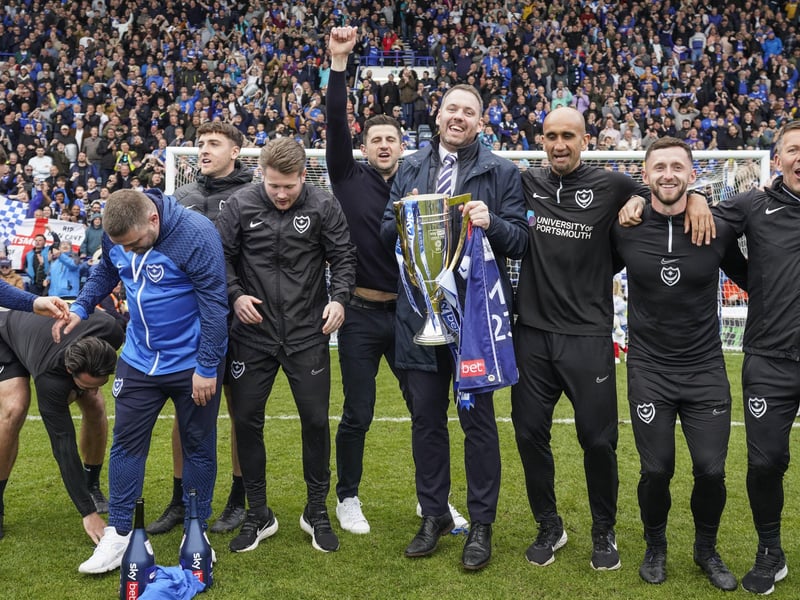 Sporting director Rich Hughes gets his hands on the League One championship trophy