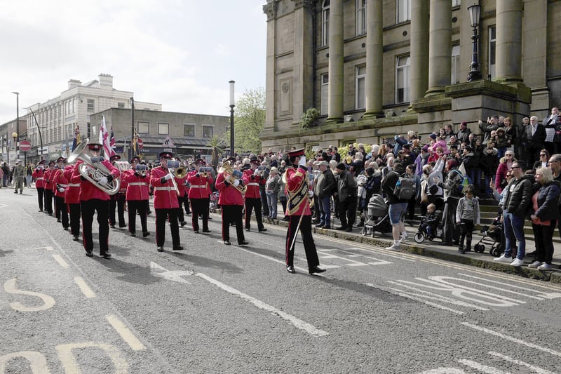 The West Yorkshire Fire and Rescue Service band lead the parade past Morley Town Hall.
