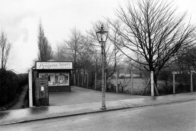 Grocers shop Progress Stores on King Lane pictured in January 1955. Window stickers advertise butter, bacon and eggs. Prices are pre-decimal and weights are imperial. A post box and a gas lamp are visible.