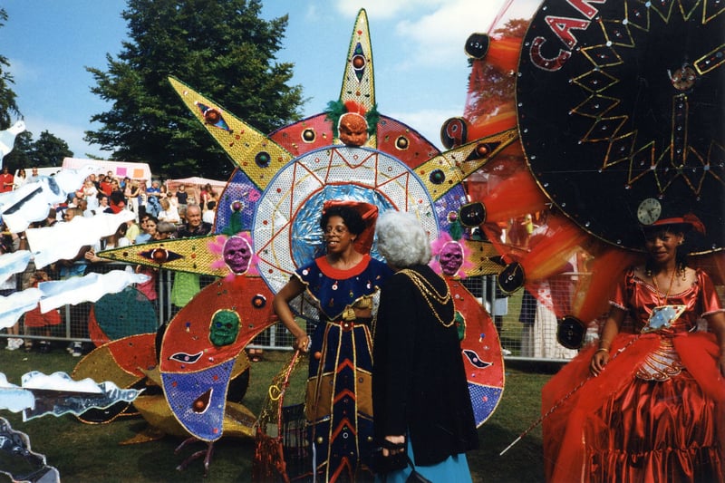 Some of the colourfully dressed participants at the Leeds West Indian Carnival at Potternewton Park in August 1997, talking to the Lord Mayor of Leeds, CounLinda Middleton.