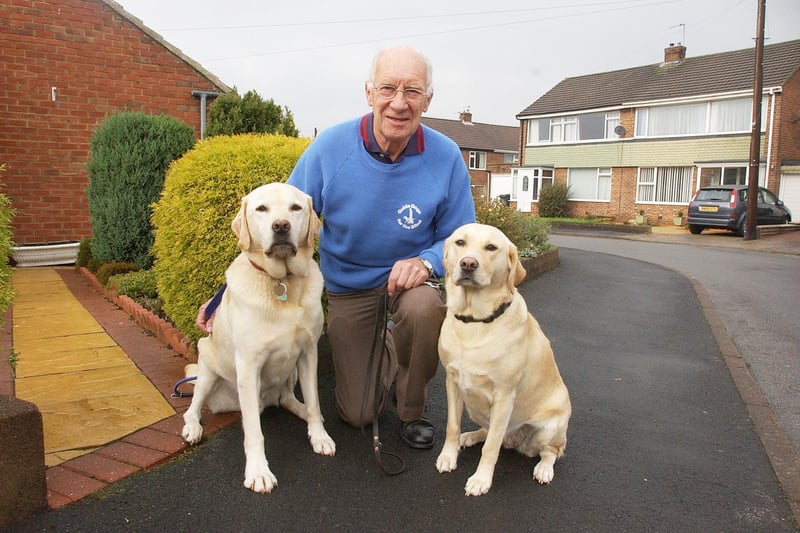 Trainer Peter Emmerson took a moment for a photo with these two beautiful creatures - trainee guide dogs George and Lizzie in October 2006.