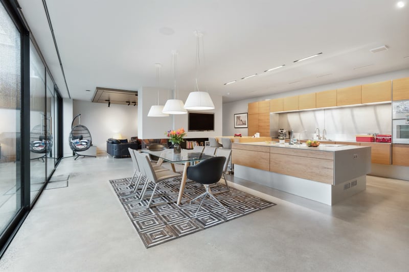 The kitchen space is designed by Allmilmo and features several integrated appliances. 