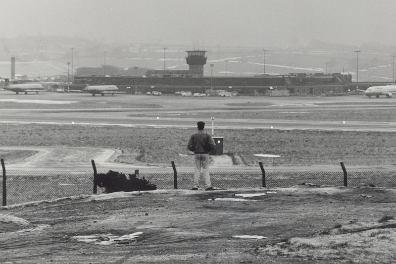 A plane spotter looks across to Leeds Bradford Airport in December 1990.
