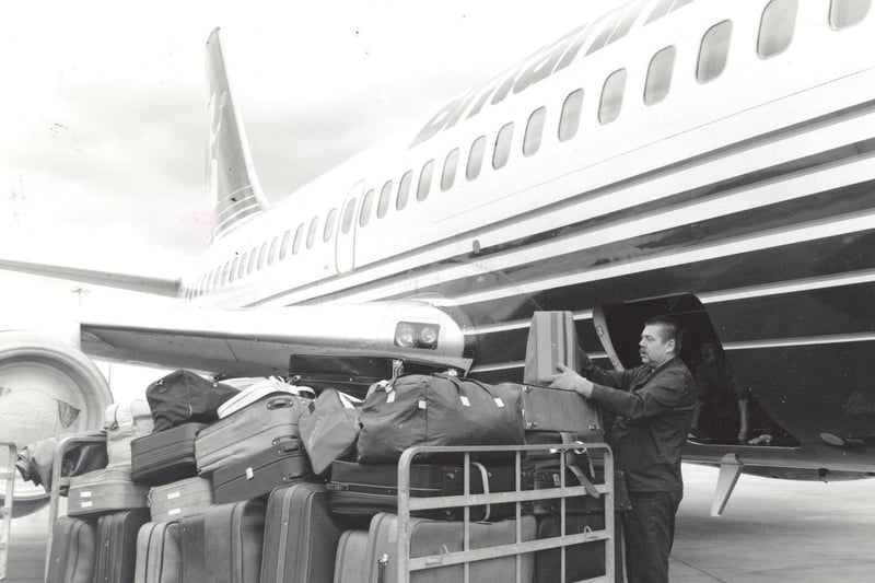 Baggage is loaded onto a holiday flight in October 1991.