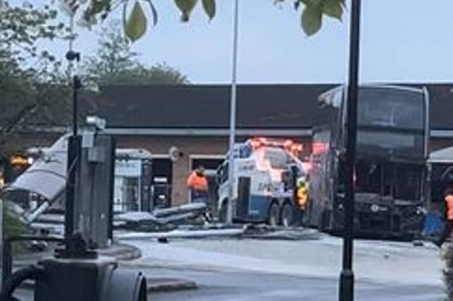 The scene after the crash yesterday, showing the damaged bus and destroyed shelter