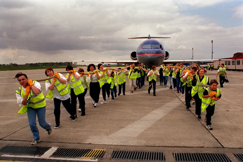 British Midland Airline staff taking part in a sponsored aircraft pull in April 1999  to raise funds for the NSPCC.