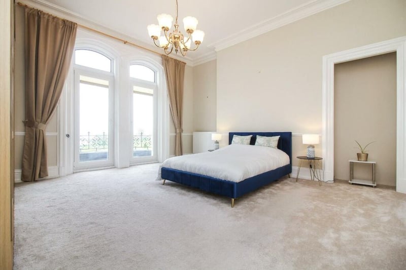 The flat has four bedrooms, with the main bedroom having a balcony that offers sea views.
