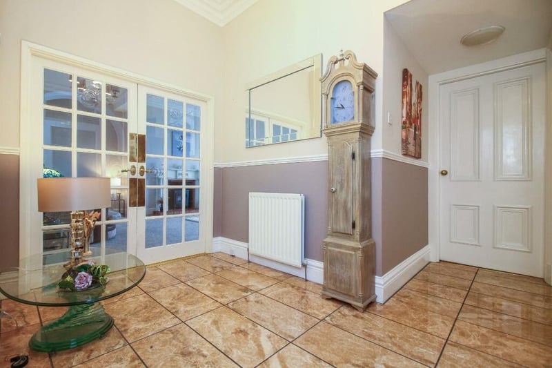 The flat's entrance hall is well presented and welcoming, with  a gleaming tiled floor.