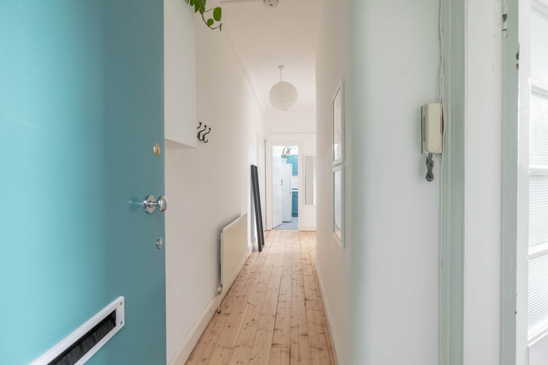 The welcoming entrance hallway with useful storage. The flat also includes a secure entry system. The property is Council Tax Band C.