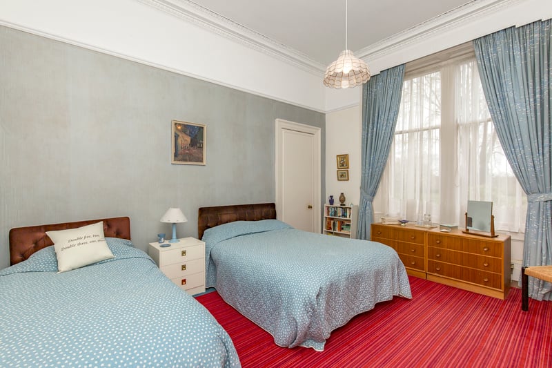 The property's second double bedroom. Extras: all fitted floor coverings, window coverings and light fittings (except the light fitting and curtains in the front living room), integrated and freestanding kitchen appliances, and a greenhouse to be included in the sale. 