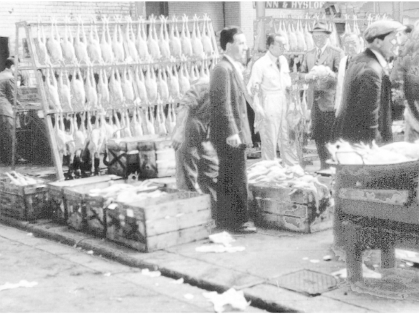 Vendors weigh salmon at the fish market in the Briggait