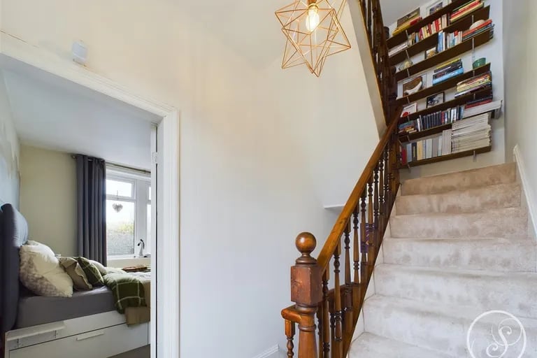 The property spans four floors connected via stairs with charming wooden handrails.