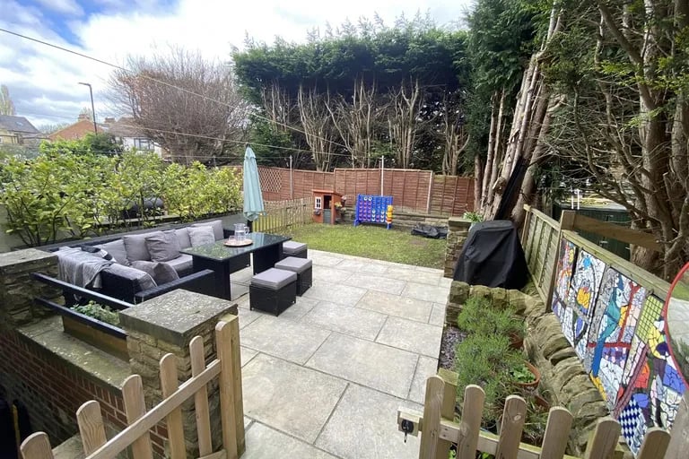 Here is an enclosed garden with lawn and planted borders and a high degree of privacy.