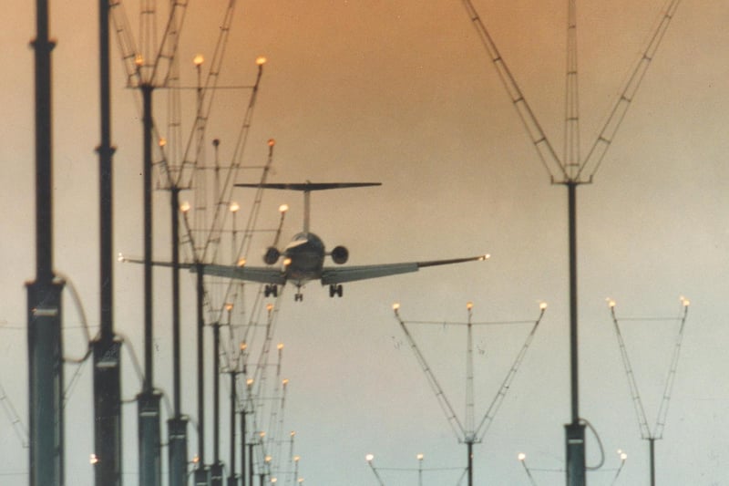 Safe landing. A jet makes a dusk approach in June 1993.