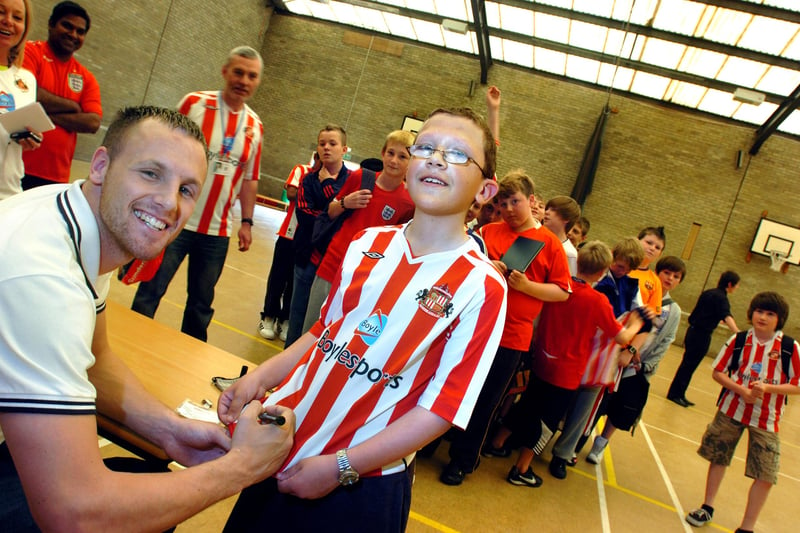 Sunderland footballer David Meyler signs the shirt of 12 year pupil old Andrew Dixon at the St Aidan's School charity football shirts day in June 2010.