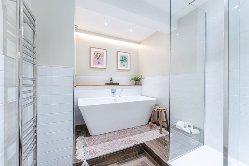 The luxurious family bathroom with four-piece suite that includes a freestanding bath and separate shower cubicle, as well as a supplementary WC off the hall.