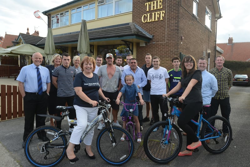 Karen Maclennan of Grace House, (front left) joined staff and regulars of The Cliff for a charity bike ride from the pub to Marsden Grotto and back in 2014.