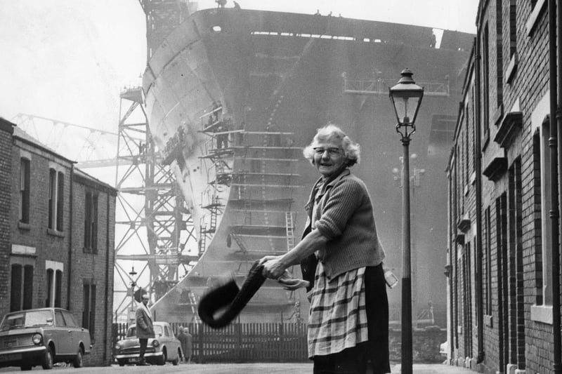 Daily chores being carried out in 1969 in the shadow of the tanker Esso Northumbria, which was to be launched on the Tyne by Princess Anne