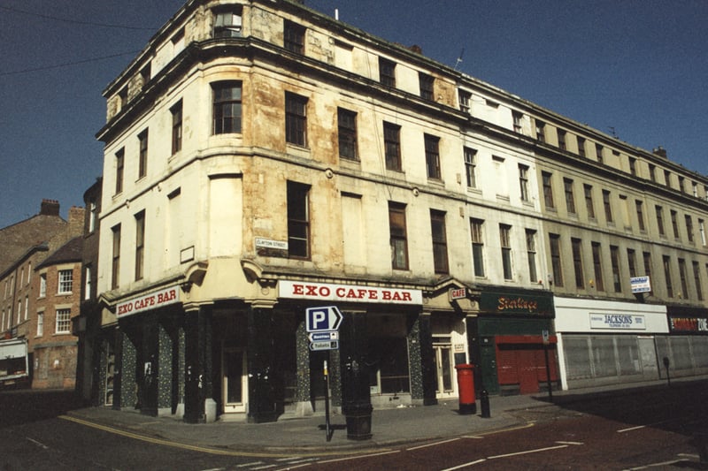  A 1995 photograph of the Exo Cafe Bar at the corner of Clayton Street and Fenkle Street. To the right of the Exo three of the adjacent shops on Grainger Street can be seen the first is unidentifiable with Jacksons beyond that and then The Kombat Zone. In the background to the left can be seen buildings in Charlotte Square.
