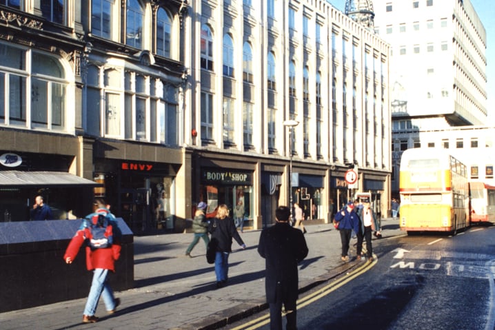  A 1995 photograph of Monument Mall on Blackett Street. Boots, Envy, The Body Shop and Burton's have shops on the ground floor of the mall. An entrance to Monument metro station is in the foreground to the left. 