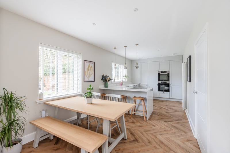 The kitchen is sleek and modern with a range of cabinets with Quartz worktops and appliances, and offers a fantastic space for cooking and socialising. Off the kitchen is a useful utility room with space for a washing machine and tumble dryer and a door out to the side of the property.