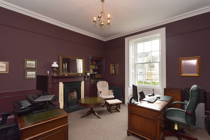 On the ground floor, is the fifth bedroom, currently transformed into a sophisticated office space adorned with a period fireplace, offering versatility to suit your lifestyle needs.
