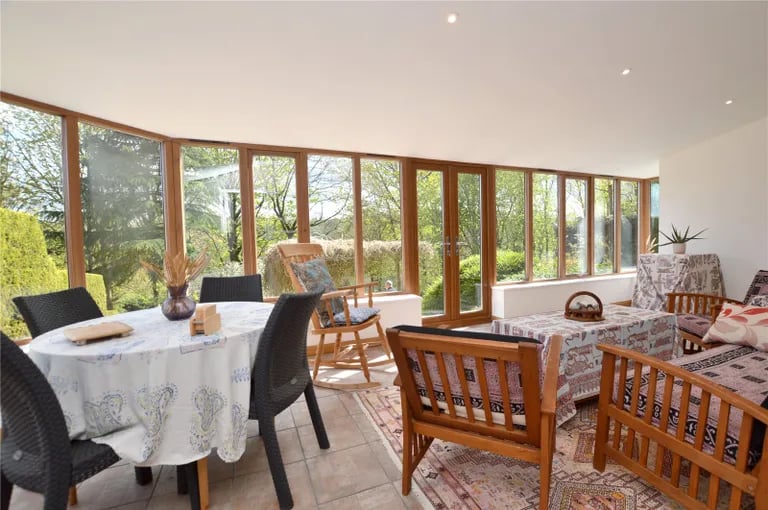 There is also a large sun room with panoramic views of the surrounding gardens.