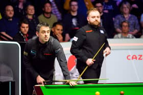 Ronnie O'Sullivan during their first round match against Jackson Page (right) on day six of the 2024 Cazoo World Snooker Championship at the Crucible Theatre, Sheffield. Picture date: Thursday April 25, 2024.  Photo: Mike Egerton/PA Wire.
