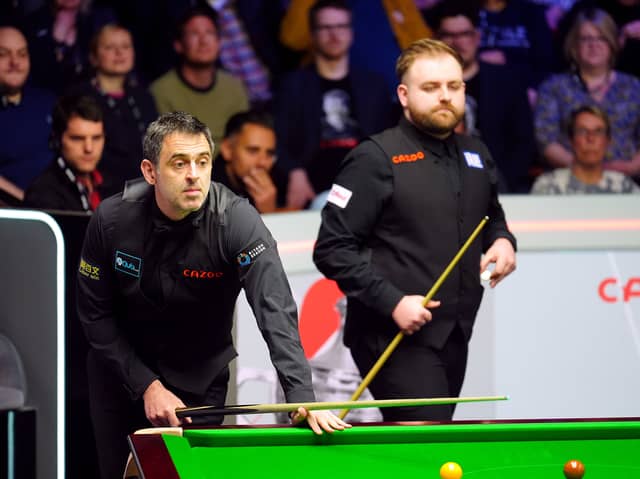 Ronnie O'Sullivan during their first round match against Jackson Page (right) on day six of the 2024 Cazoo World Snooker Championship at the Crucible Theatre, Sheffield. Picture date: Thursday April 25, 2024.  Photo: Mike Egerton/PA Wire.