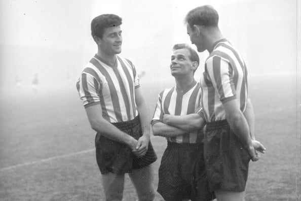 Ernie Taylor looks up to the giant Roker pairing of The King and Don Kitchenbrand in this December 1958 training ground photo.