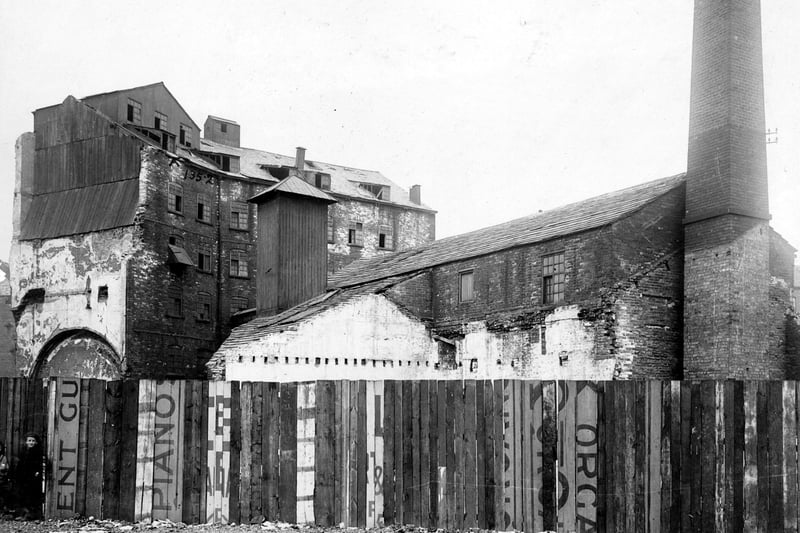 Part of the Swinegate Sovereign Street Improvement area pictured in July 1905. Mill and factory buildings can be seen. Corn mills were numerous in this area, including the historic Kings Mills. The River Aire powered water wheels to grind the corn. Until 1839 Leeds people were obliged to have their corn ground at the Kings Mill. A carved stone is set onto the riverbank to mark the site.