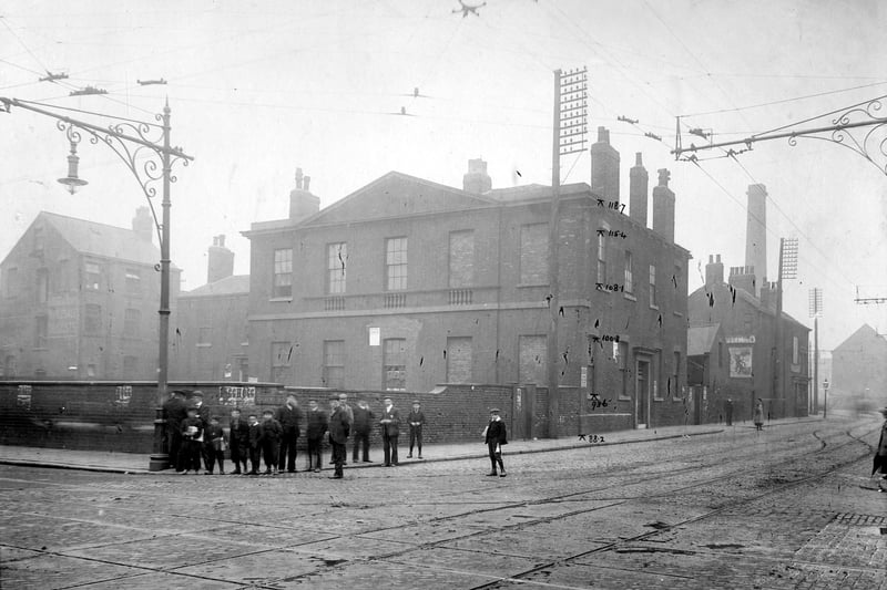 A view of junction of Meadow Lane (Left) with Great Wilson Street. A group of boys and men stand on corner. Pictured in July 1905.