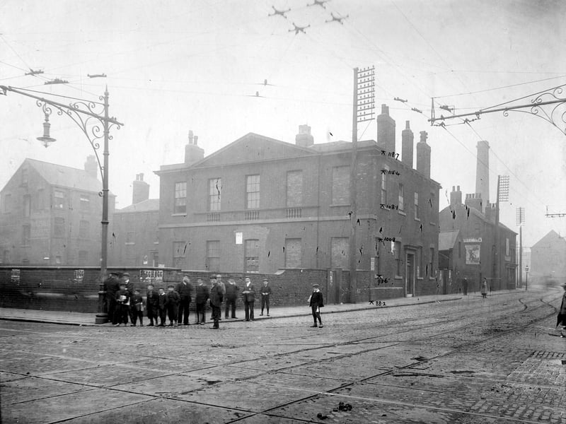 A view of junction of Meadow Lane (Left) with Great Wilson Street. A group of boys and men stand on corner. Pictured in July 1905.