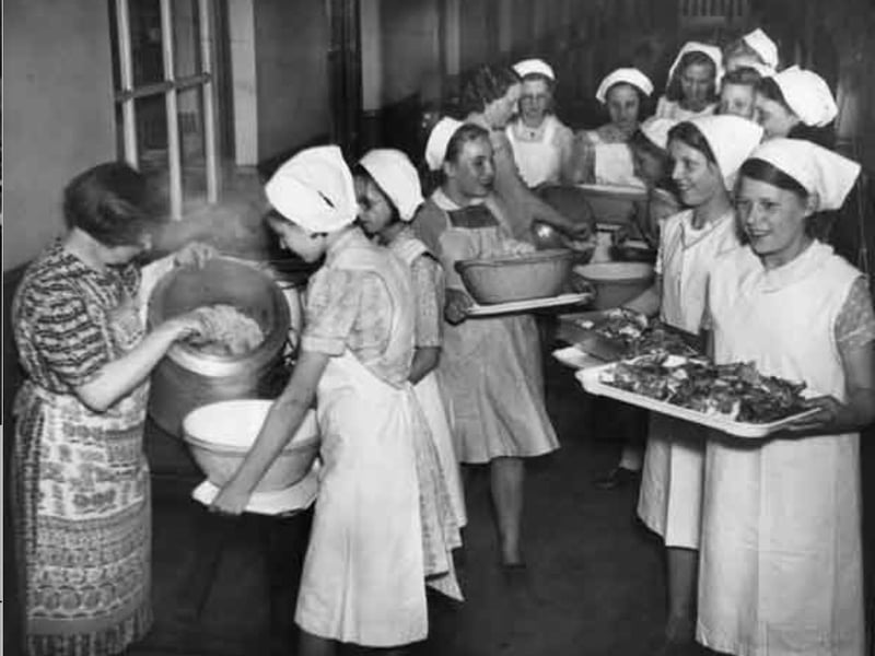 Portions being served in readiness for dinner at a Sheffield school in the 1950s Photo: Picture Sheffield