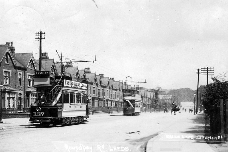 A postcard view of Roundhay Road with a postal date of August 25, 1905. A row of terraced housing is seen from the left while two trams are on the road including open-top no. 157 in front bound for Beeston.