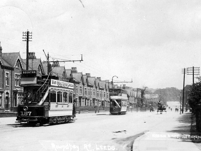 A postcard view of Roundhay Road with a postal date of August 25, 1905. A row of terraced housing is seen from the left while two trams are on the road including open-top no. 157 in front bound for Beeston.